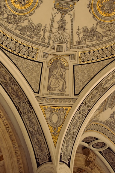 the ceiling of a building with a painting on it