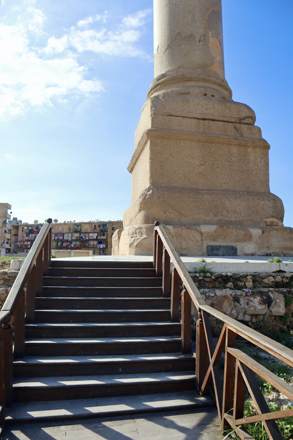 a stairway leading up to a monument with a sky background