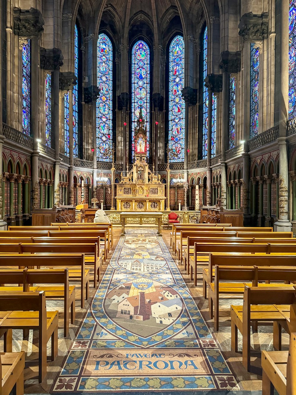 a church with stained glass windows and pews