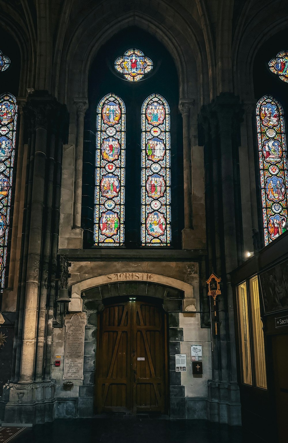 a church with stained glass windows and a wooden door