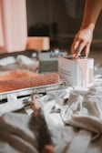 a person putting something in a box on a bed