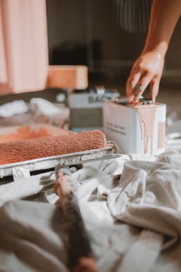 a person putting something in a box on a bed