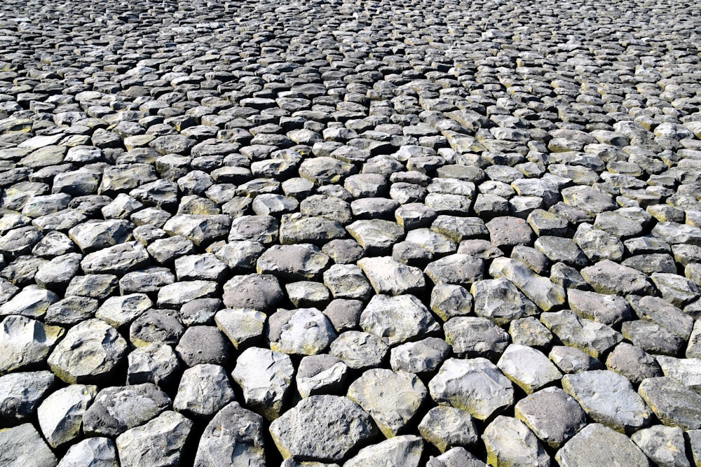 a cobblestone street with a stop sign in the distance