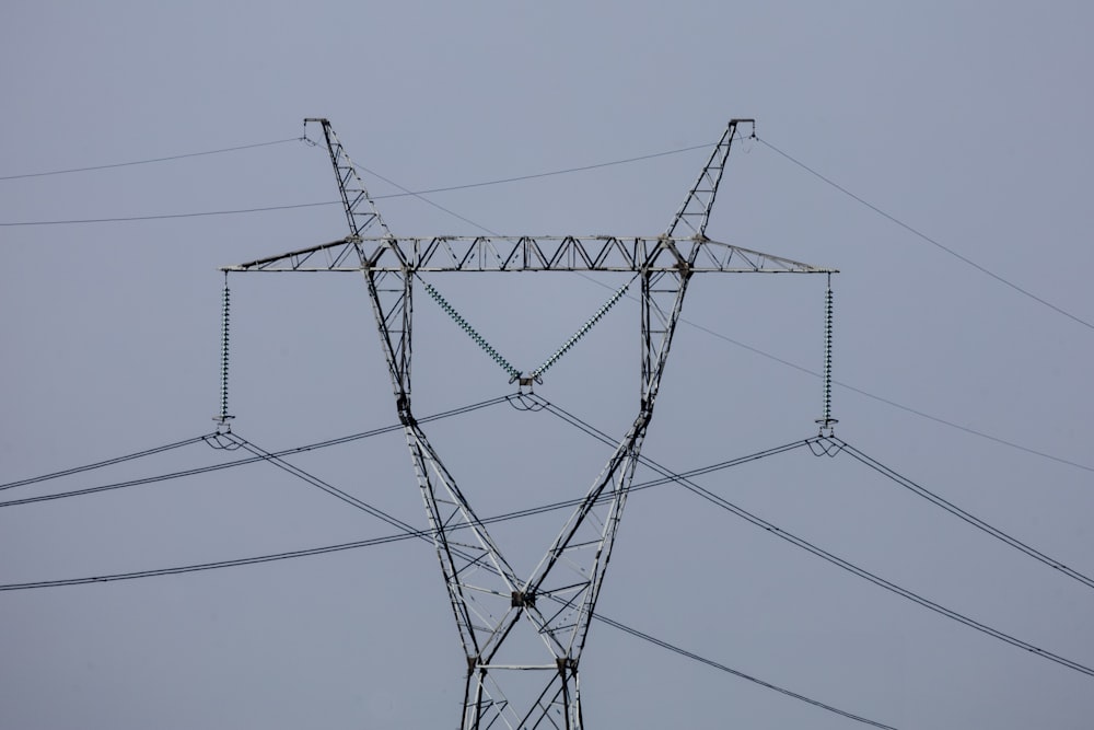 a high voltage power line against a gray sky