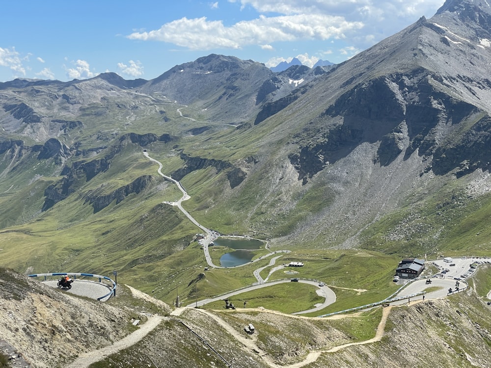 a scenic view of a winding road in the mountains