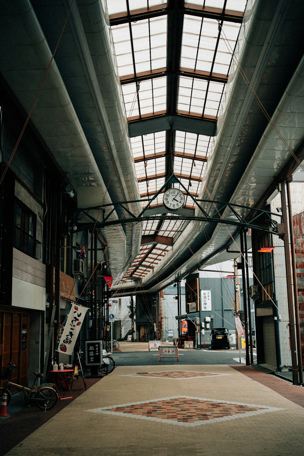 an empty warehouse with a clock on the ceiling