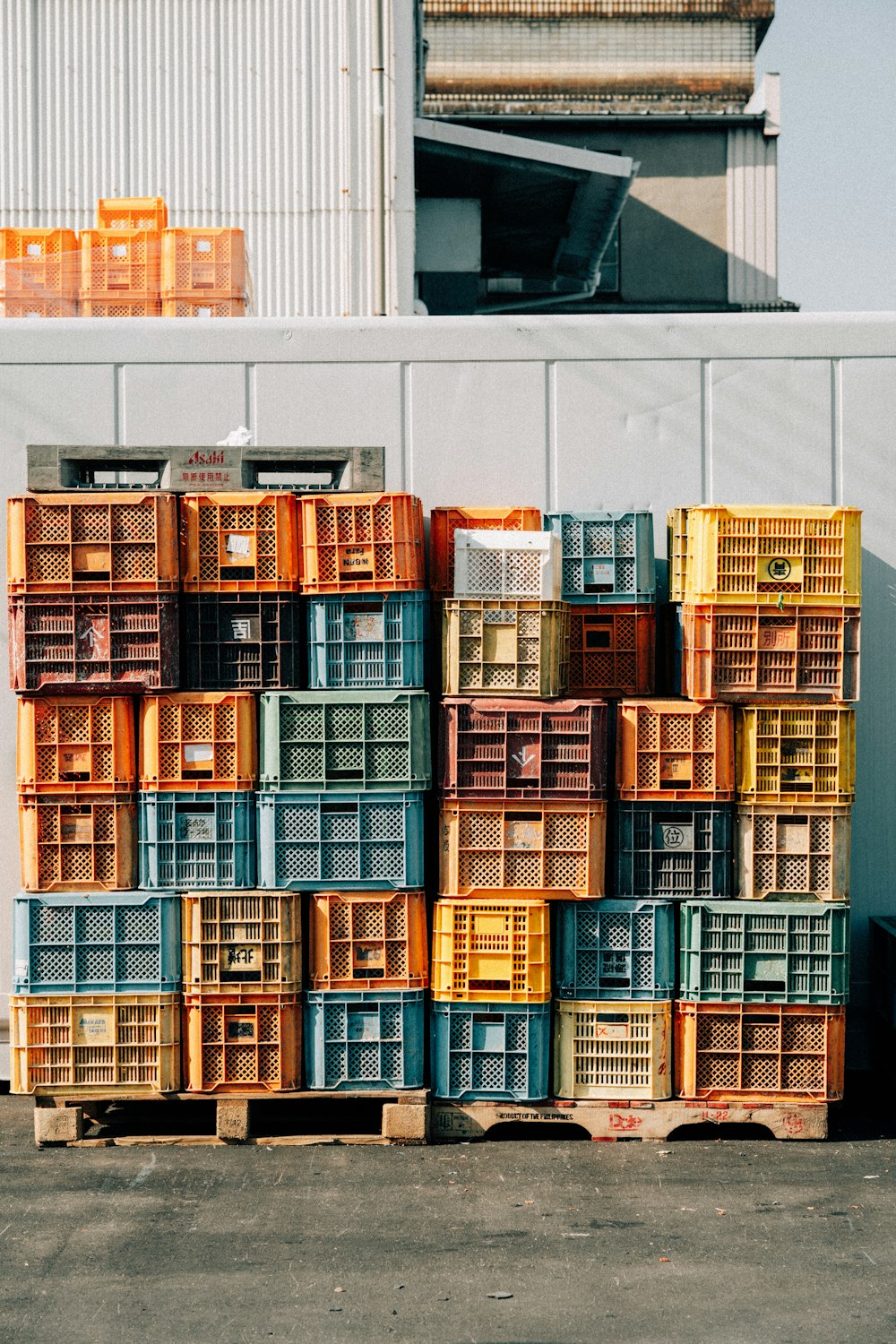 a pile of crates sitting next to a building