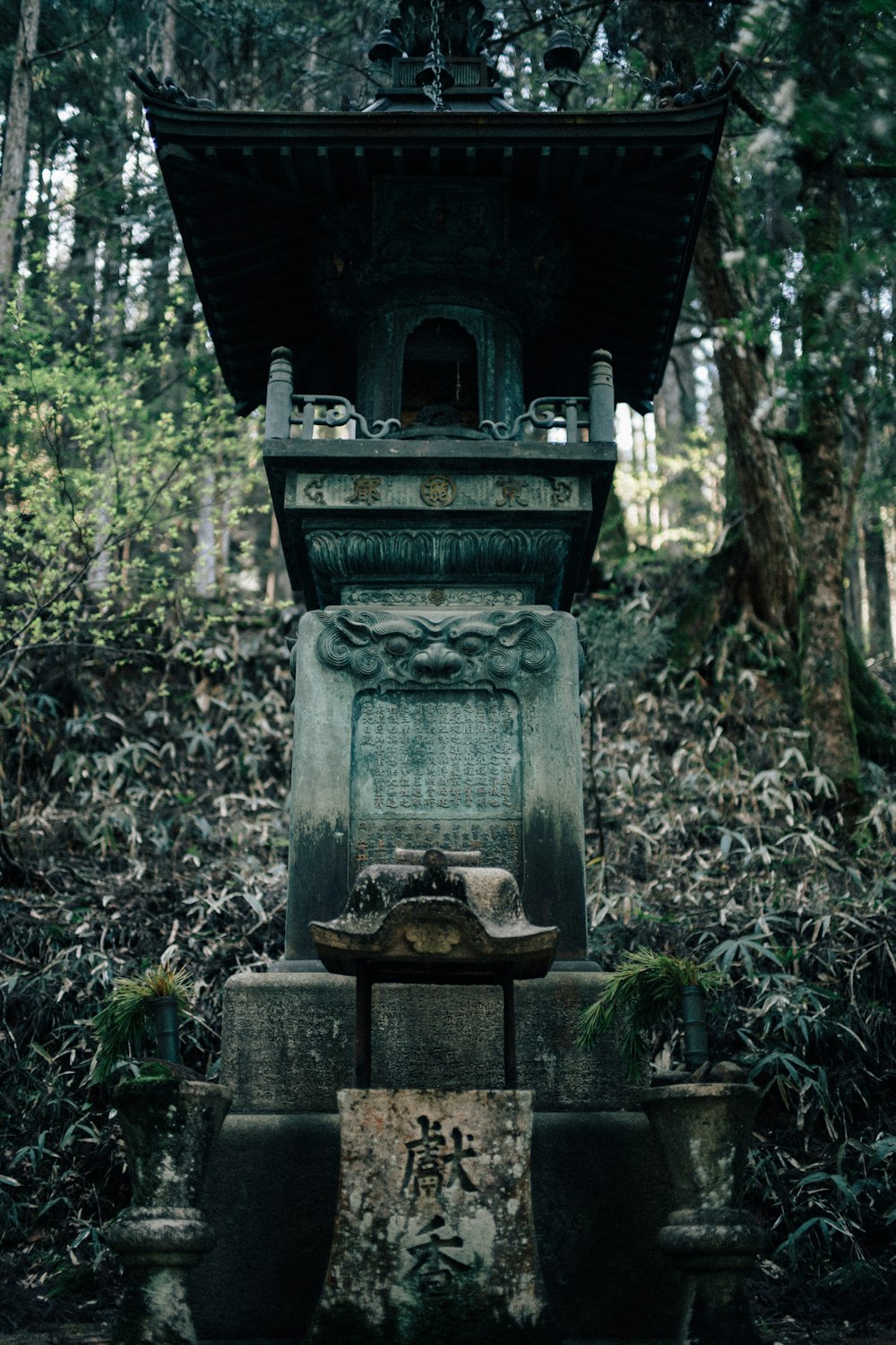 a small shrine in the middle of a forest