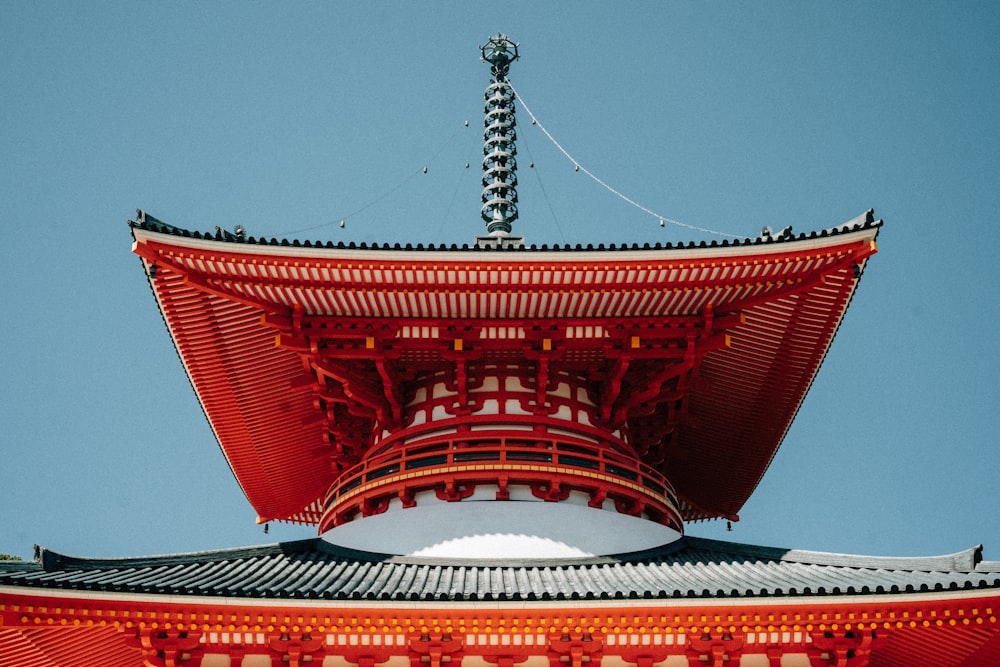 a tall red building with a sky background