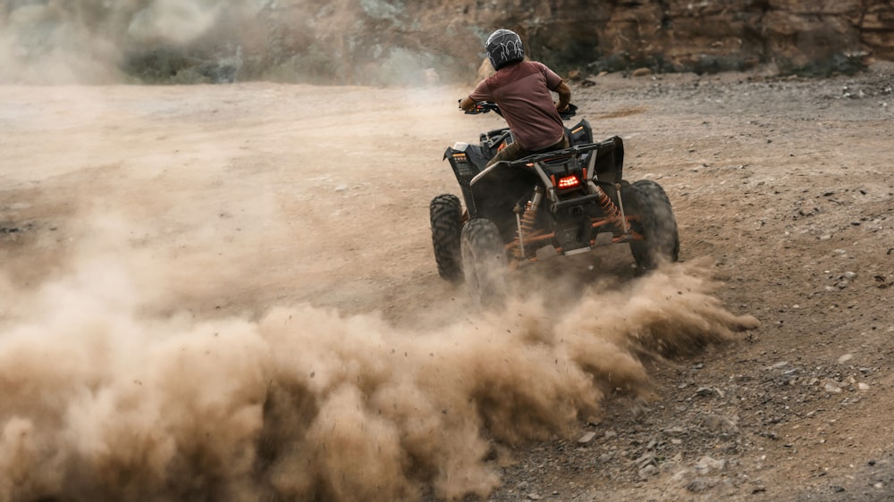 a person riding an atv on a dirt road