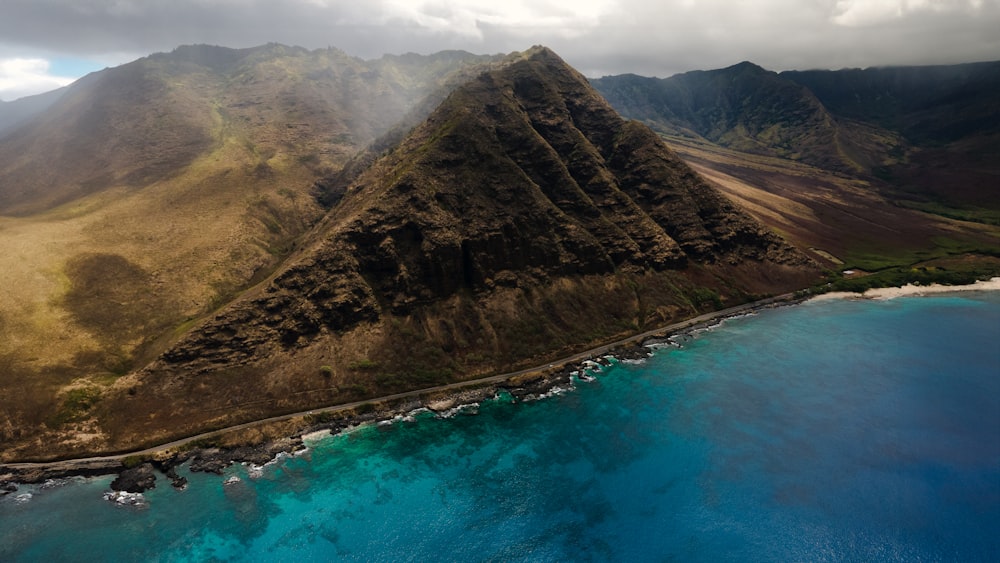 an aerial view of a mountain and a body of water