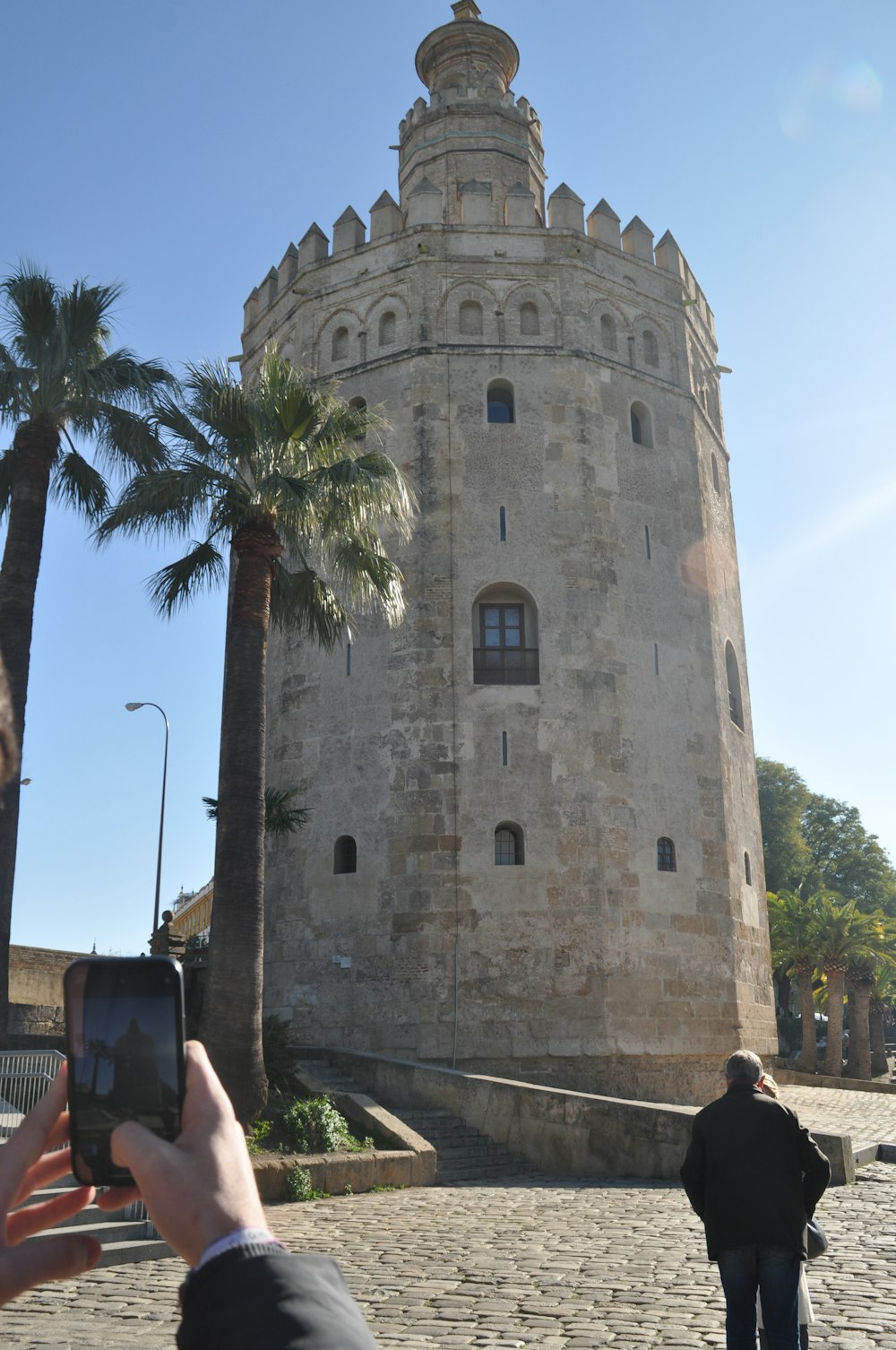 a person taking a picture of a tower