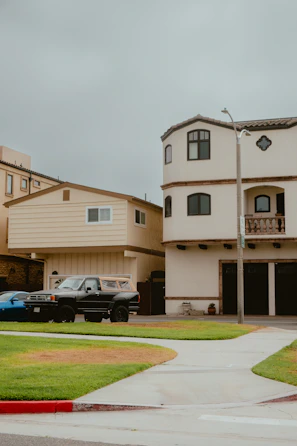 a couple of cars parked in front of a house