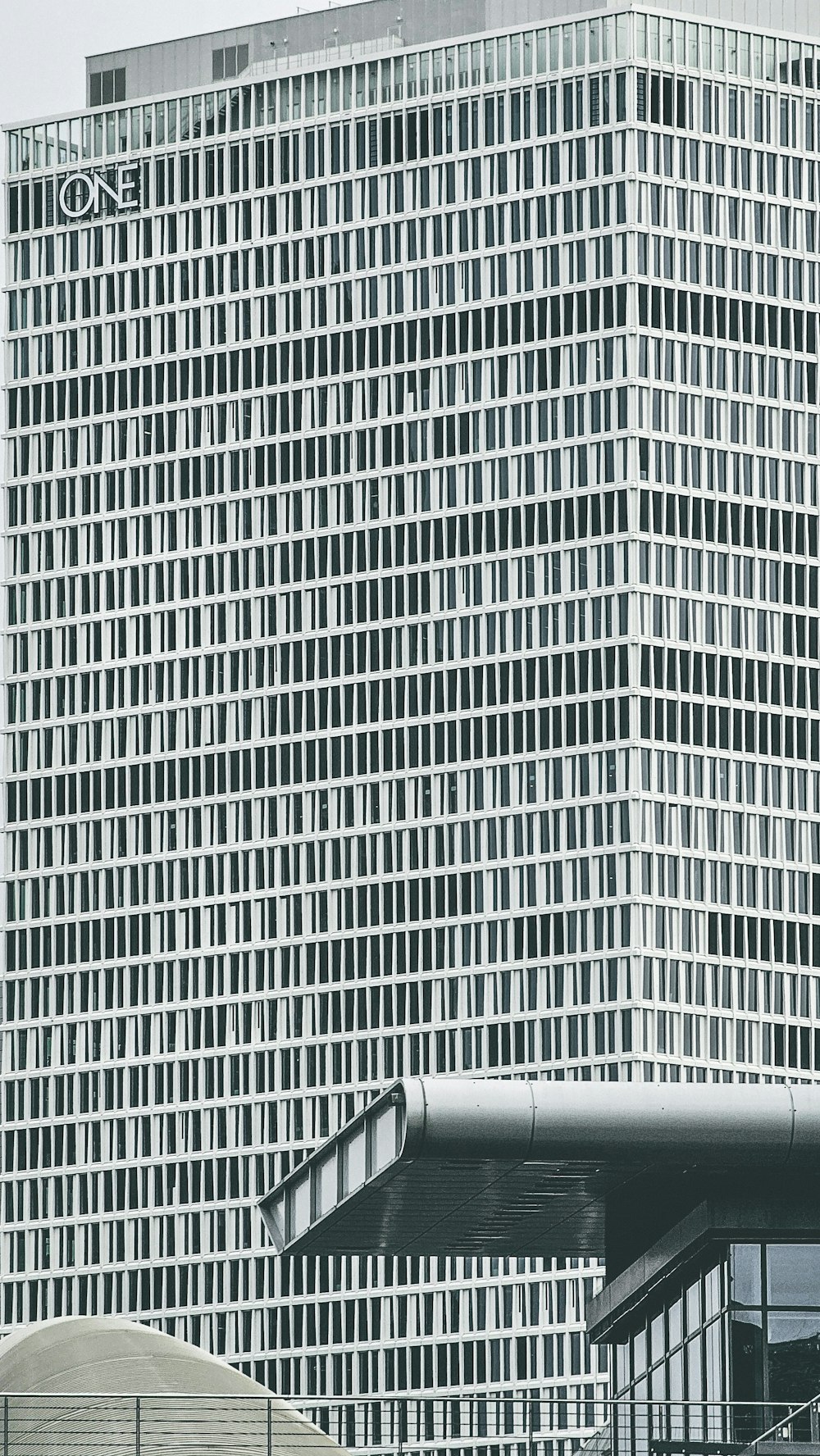 a man riding a skateboard down a ramp in front of a tall building