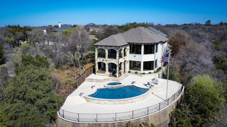 an aerial view of a large house with a swimming pool