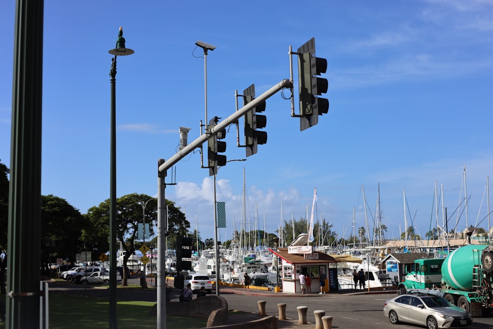 a traffic light hanging over a street next to a marina