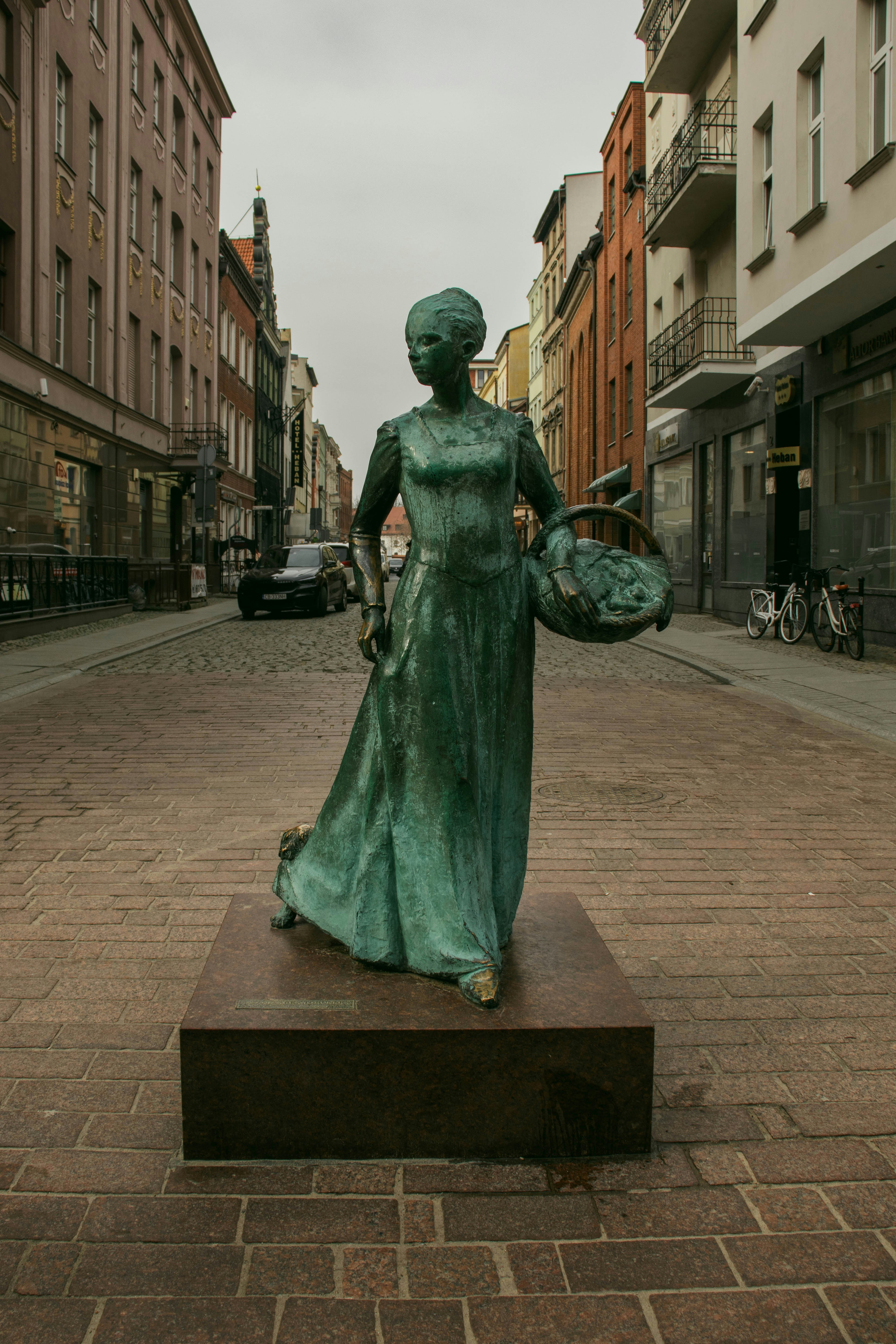a statue of a woman in a green dress