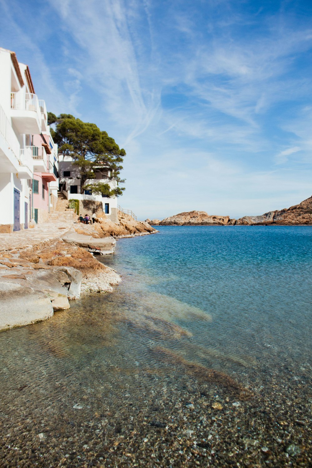 a body of water sitting next to a white building