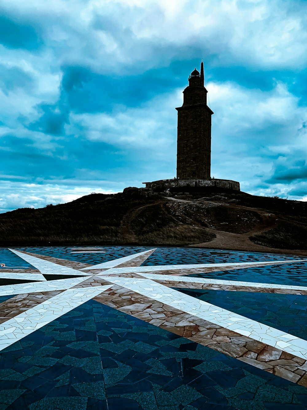 a clock tower sitting on top of a hill