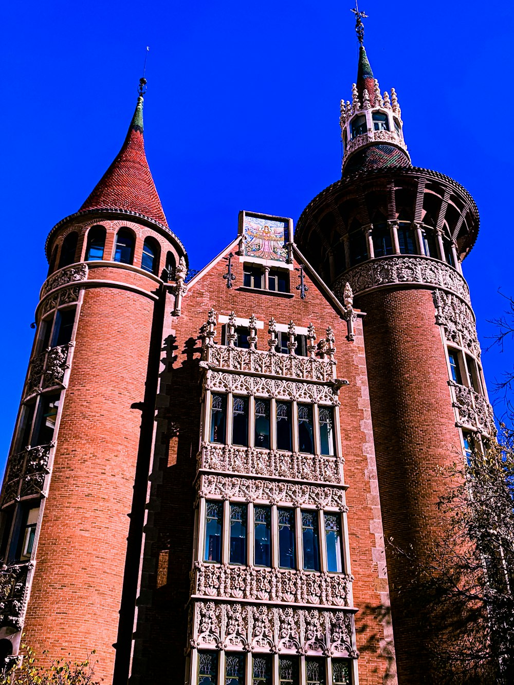 a tall brick building with a clock on it's side