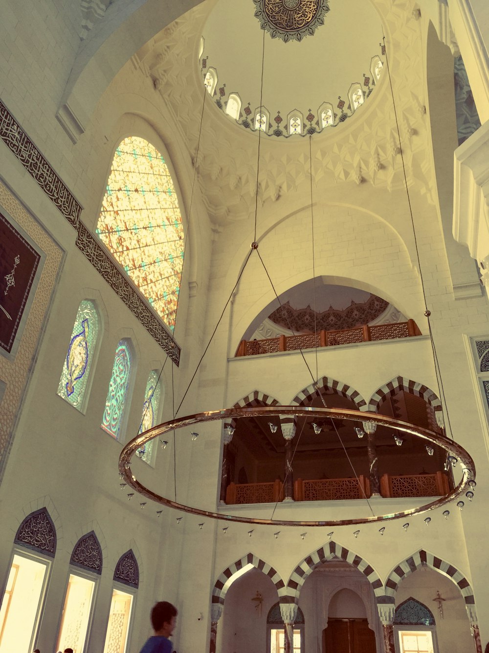 the inside of a large building with stained glass windows