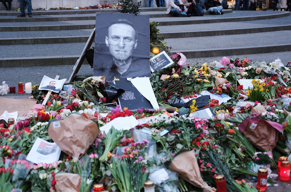 a bunch of flowers and a picture of a man