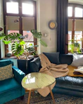 a living room filled with furniture and lots of windows