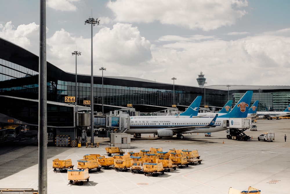 a group of airplanes parked at an airport