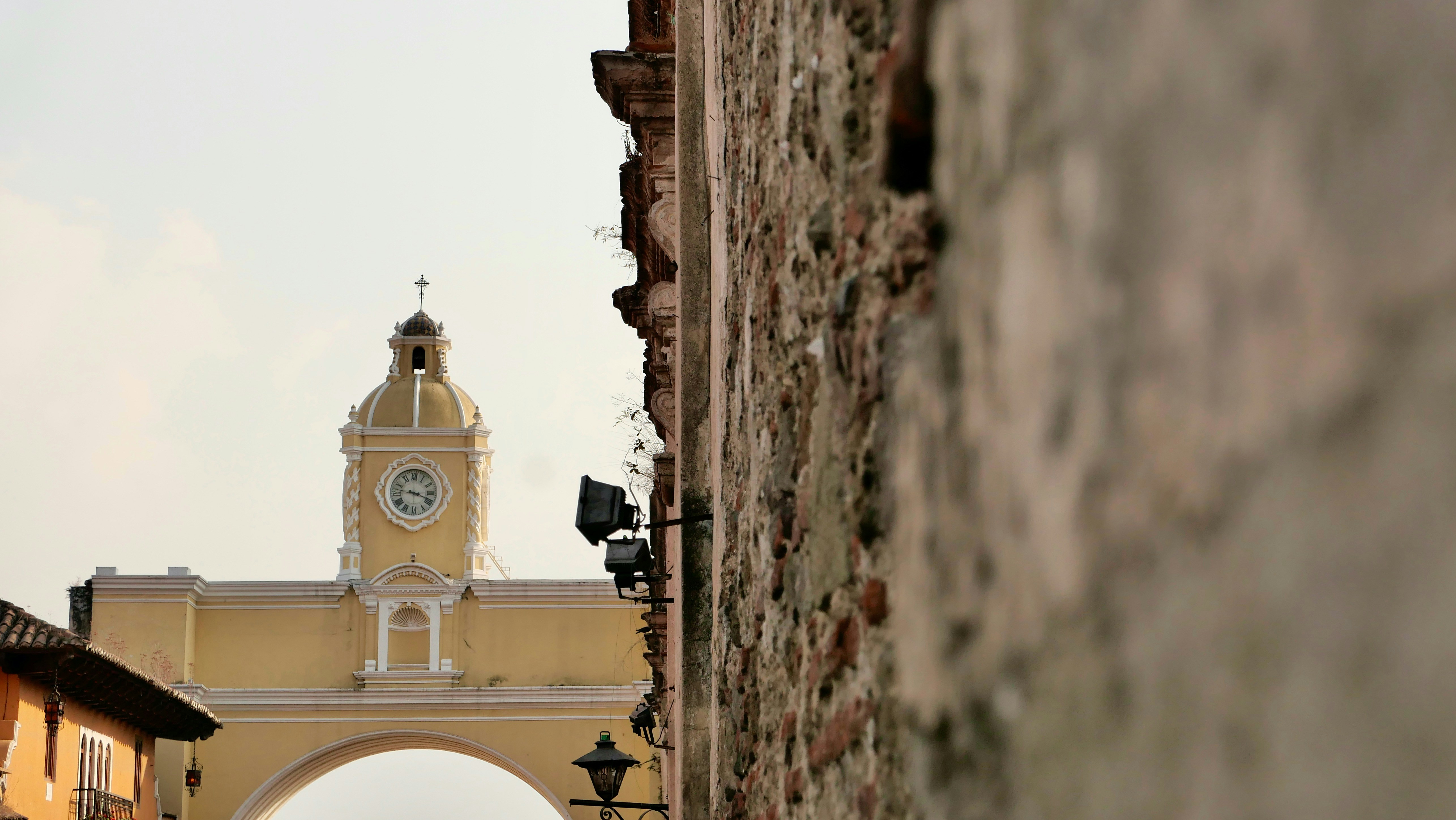 a yellow building with a clock tower in the background