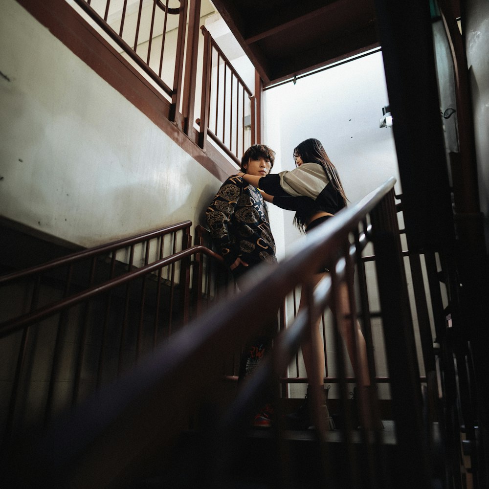 a couple of people that are standing on some stairs