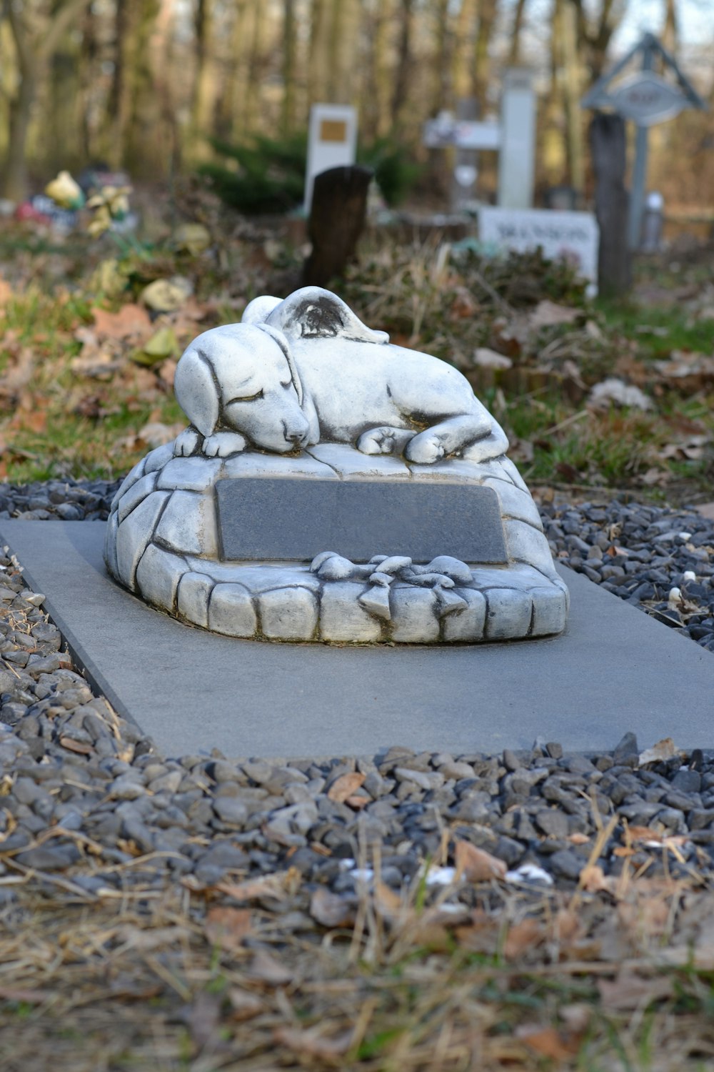 a statue of a dog laying on a stone bench