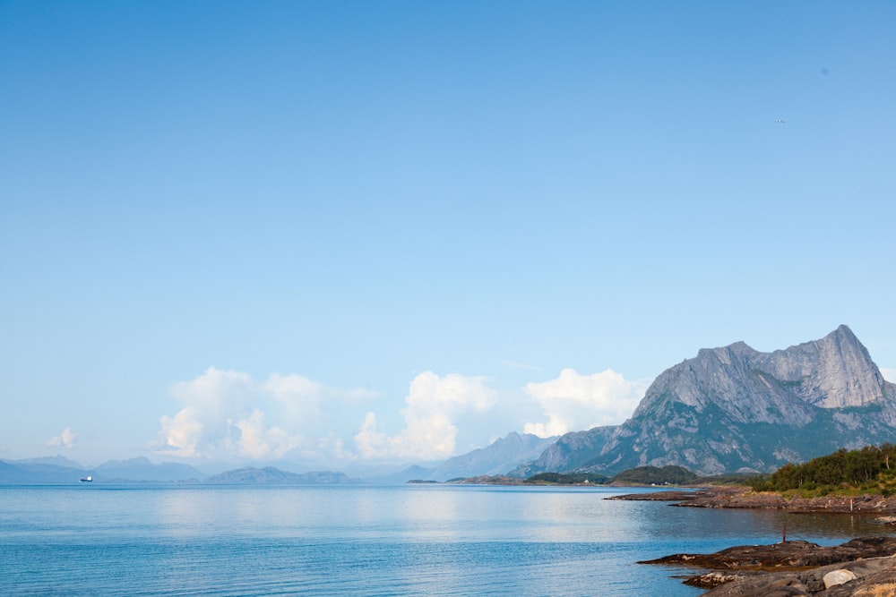 a large body of water with mountains in the background