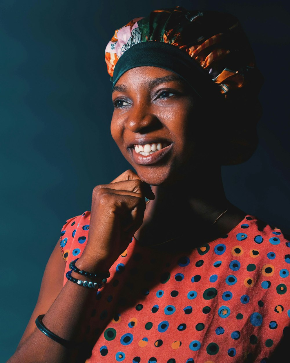 a woman wearing a colorful dress and a head scarf