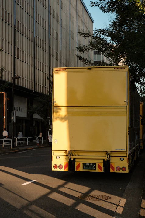 a yellow truck parked on the side of the road