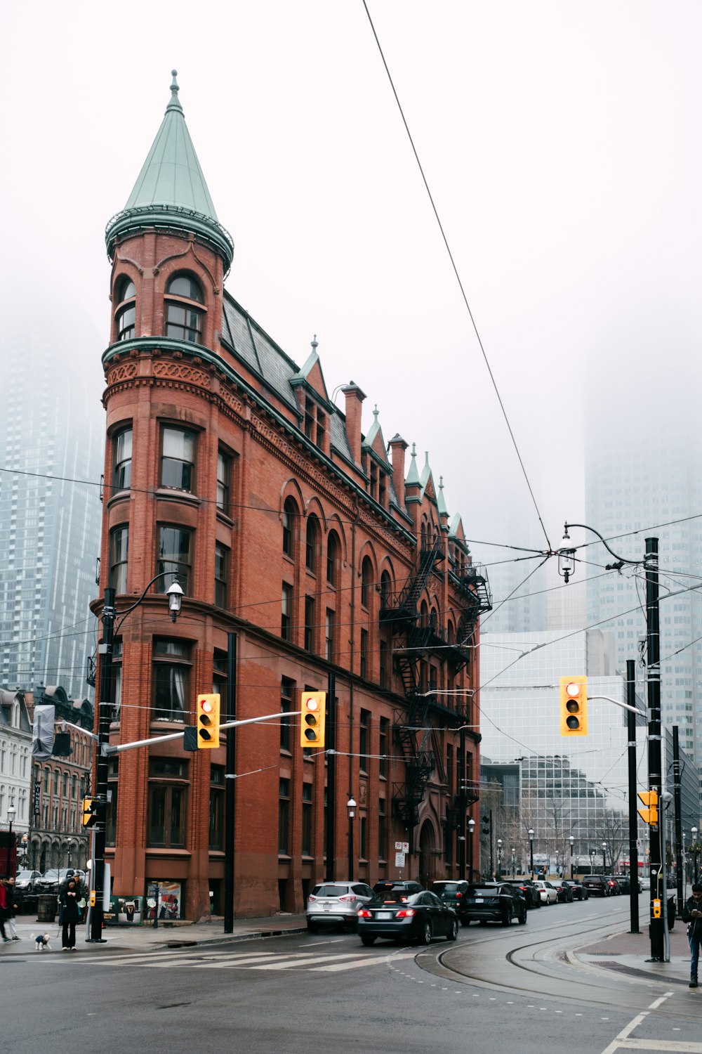 a red brick building with a green steeple