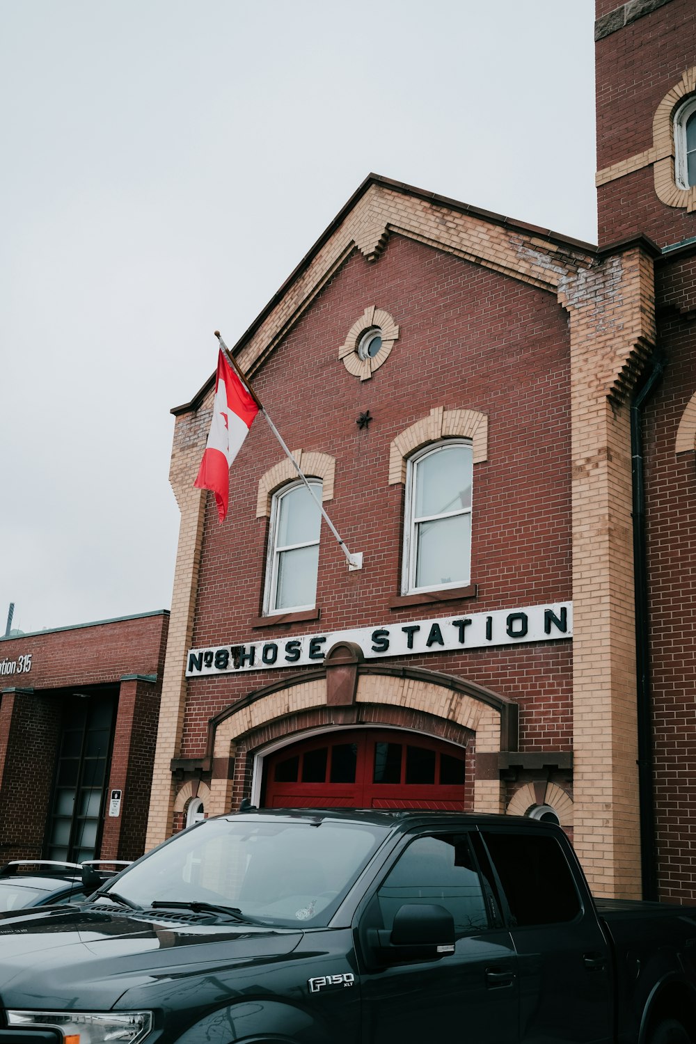 a truck parked in front of a red brick building