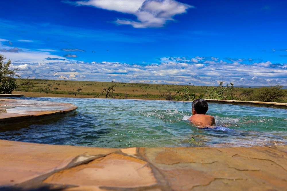 a man swimming in a large pool of water