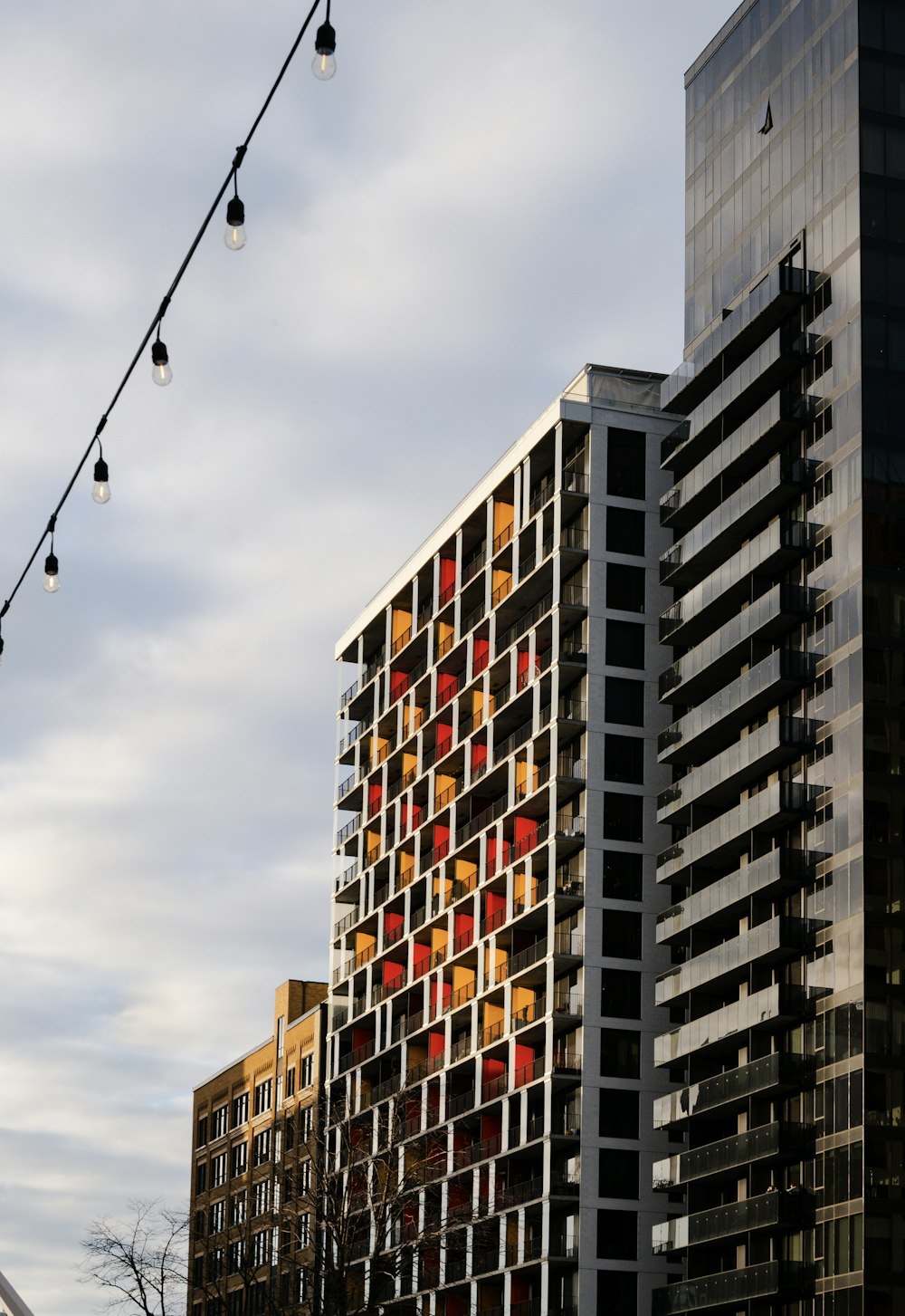 a tall building with a lot of windows next to a street light