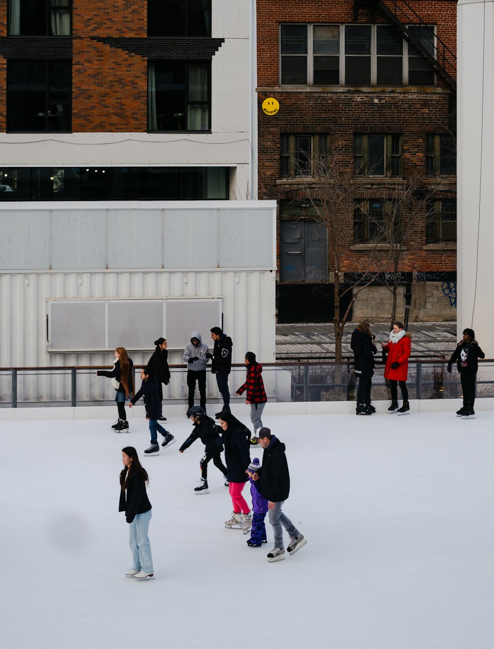 a group of people skating on an ice rink