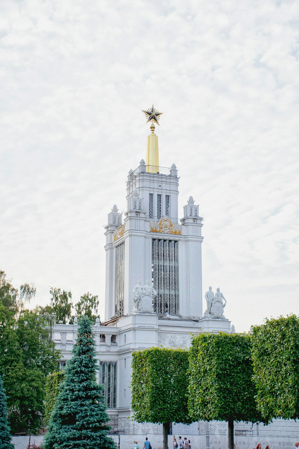 a tall white building with a gold star on top