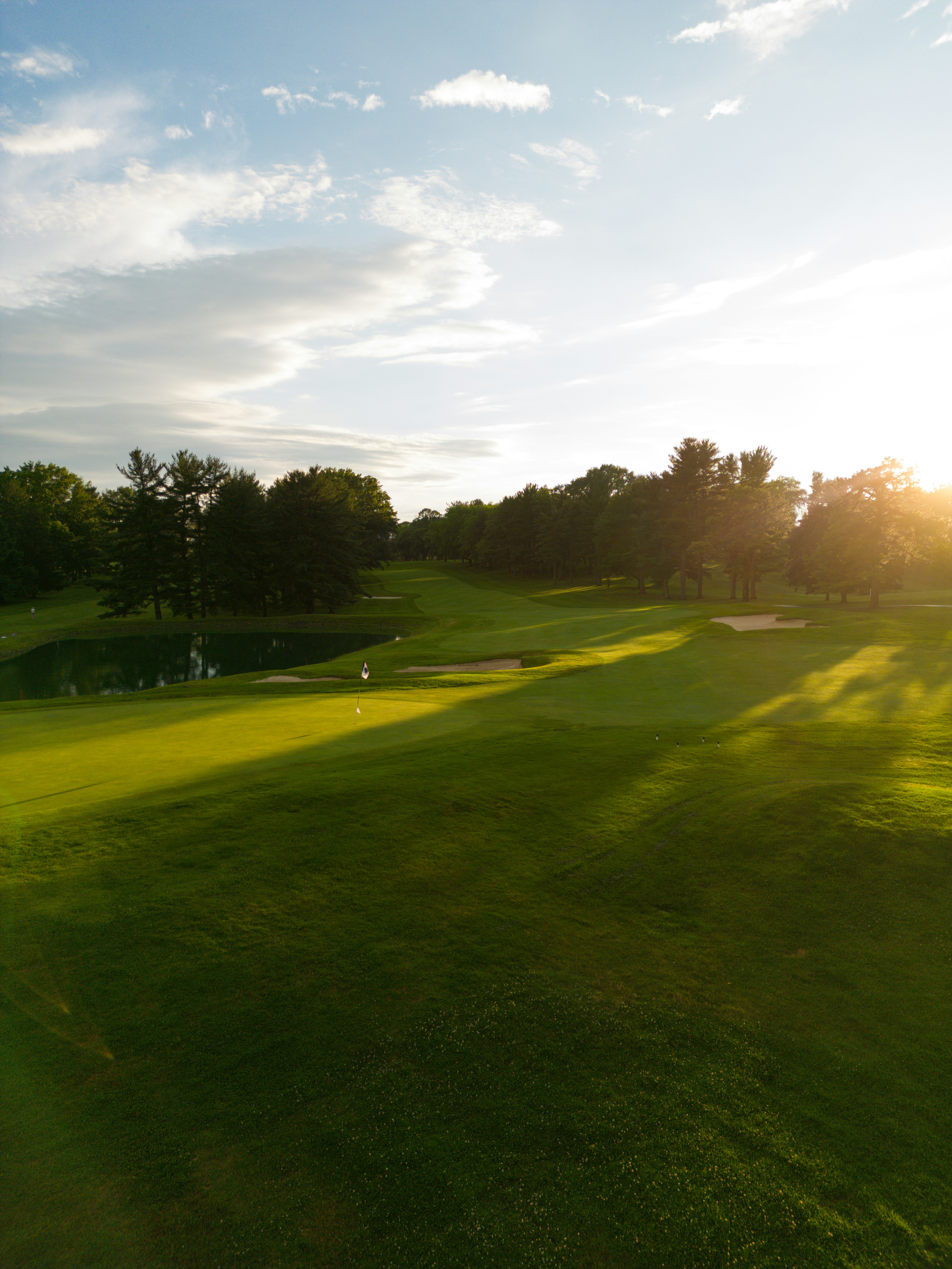 Golf hole surrounded by ocean and lush greenery