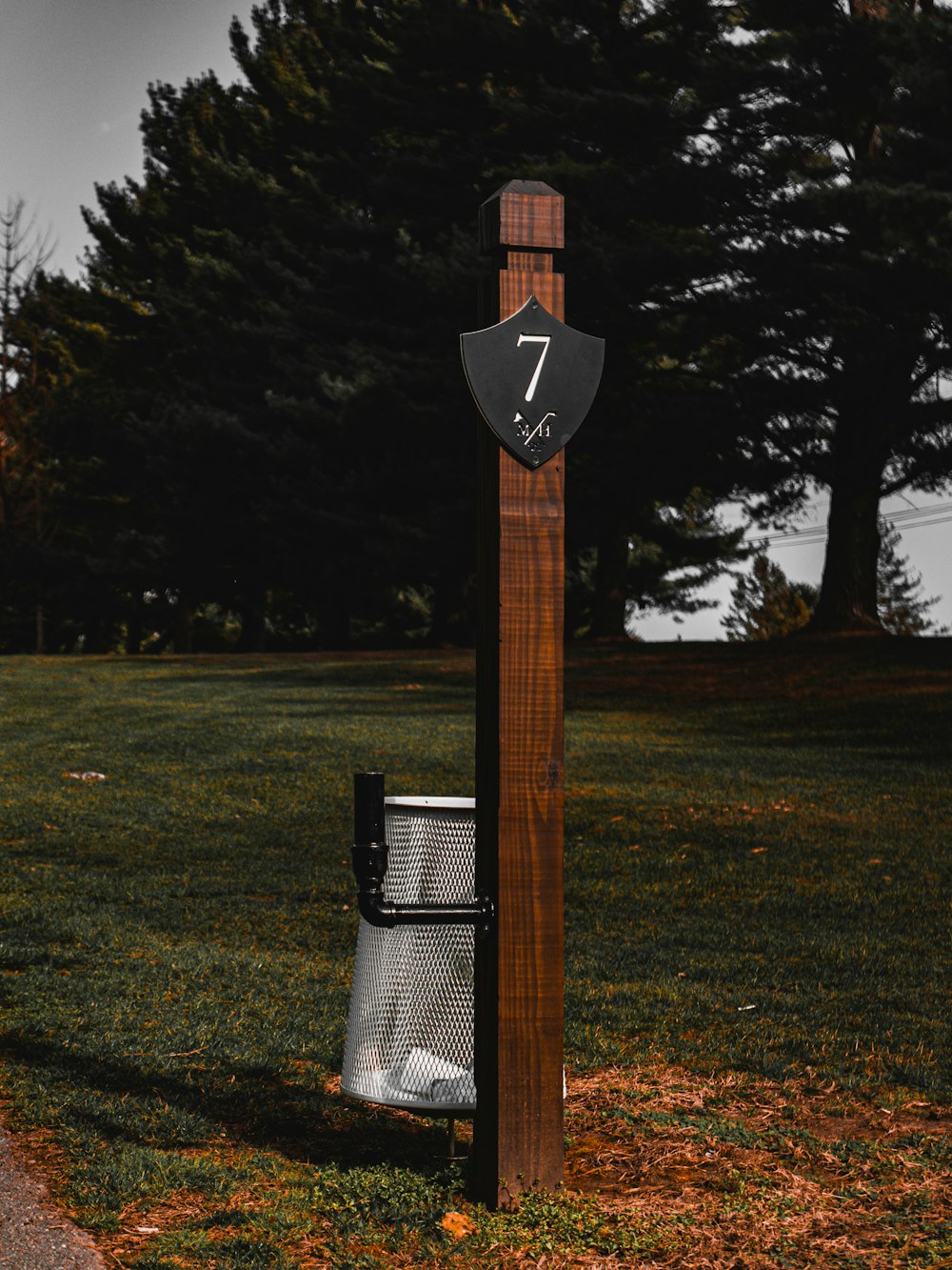 a wooden pole with a clock on top of it