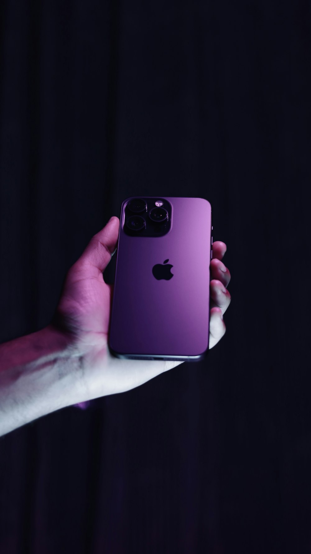 a person holding a purple iphone in their hand