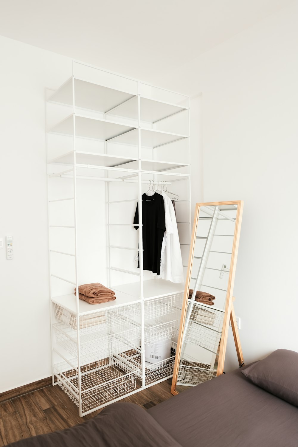 a bedroom with a bed and a white shelving unit