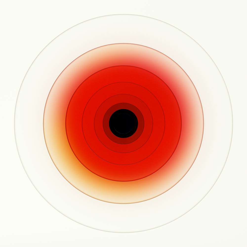 a red and white circle with a black center