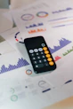 smartphone calculator app on financial report papers