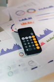 smartphone calculator app on financial report papers