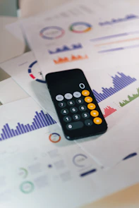 smartphone calculator app on financial report papers
