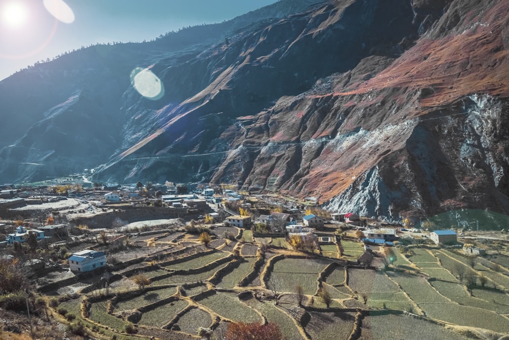 a view of a mountain with a village in the foreground