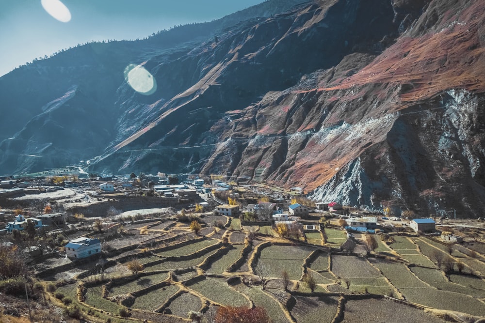 a view of a mountain with a village in the foreground